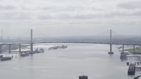 tracking shot of Queen Elizabeth II Bridge , Dartford Thurrock River Crossing, fly zoom out alt