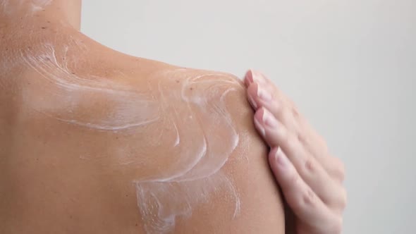 Shoulder and Woman Back Body Lotion Spreading Slow Motion Closeup alt