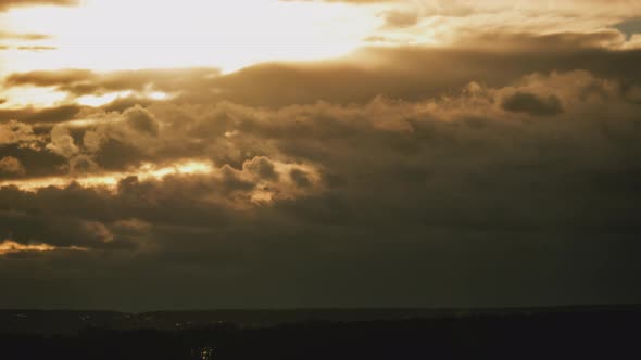 Dramatic Sunset in the Sky Through Orange Layered Cumulus Clouds Timelapse alt