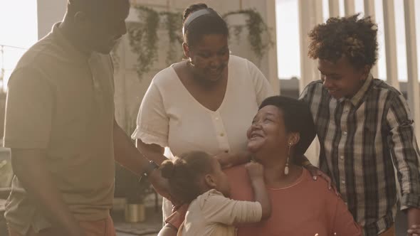 Happy Woman Celebrating Birthday with Family alt