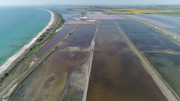 Amazing drone aerial landscape of the beautiful salt ponds, near the beach alt
