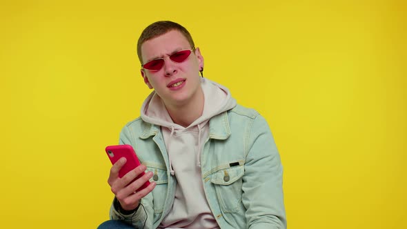 Teen Man Use Mobile Phone Browsing Loses Surprised Sudden Lottery Results Bad Fortune Loss alt