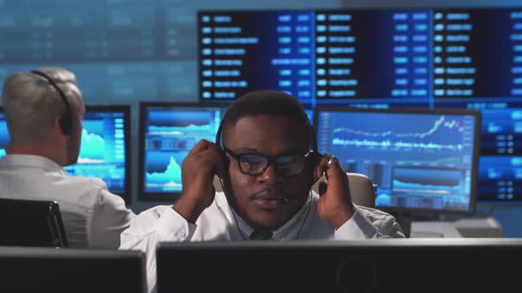 Diverse team of brokers workin in office using workstation and analysis technology. alt