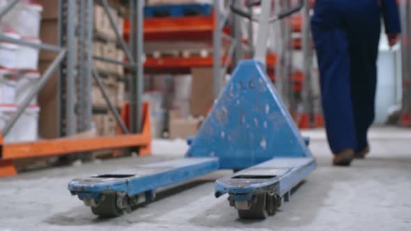 Warehouse Worker Pulling Platform Cart alt