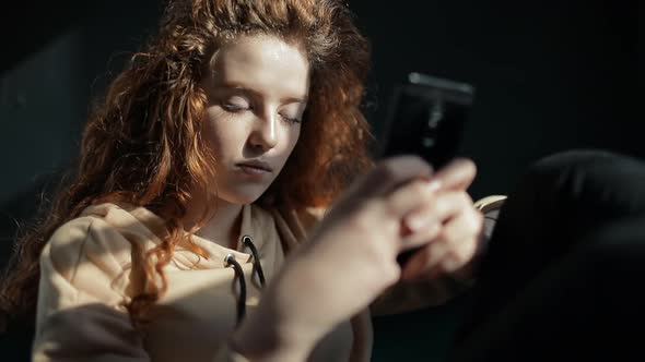 A Young Girl Having Fun While Using Smartphone alt