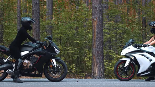 Motor Riding  Two Women in Helmets Meeting Each Other on the Side of a Road on Motorcycle alt