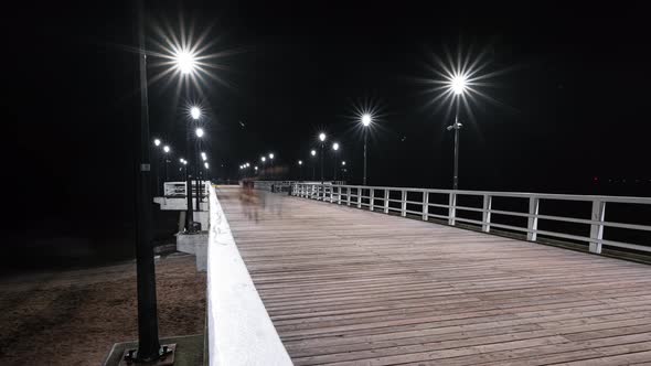 Time Lapse of People Walking on a Sea or Ocean Wooden Pier by the Beach at Night