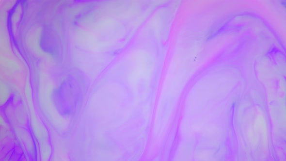 Ink in Water. Purple Ink Reacting in Water Creating Abstract Background.