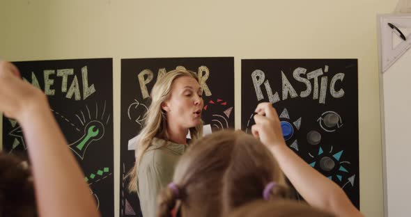 Female teacher teaching kids in the class alt