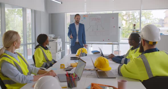 Construction Company Executive Presenting New Project to Architect Team alt