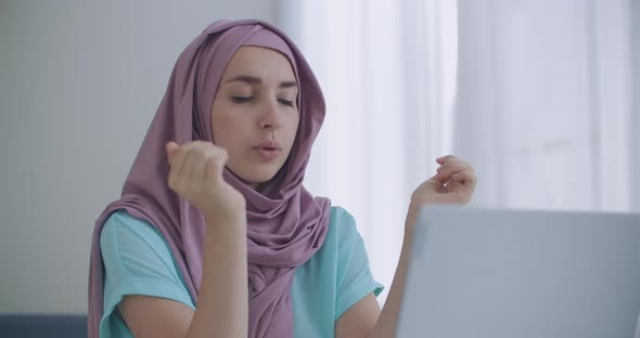 Young Indian Business Woman Wears Hijab Communicates with Distance Worker in Webcam Conference Chat alt
