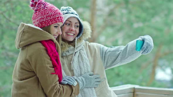 Joyful Girls Taking Picture on Winter Nature alt
