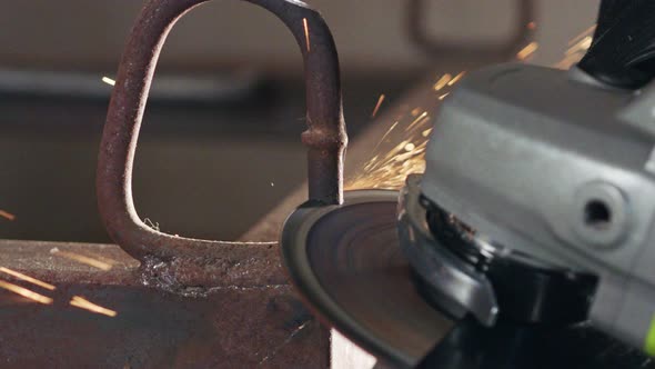 Slow motion of a metal grinder during work with sparks flying alt