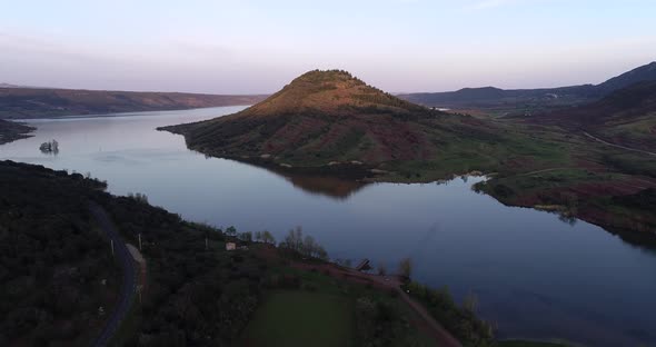 Lac Du Salagou with Rocky Red Ground and Mountains in the Background