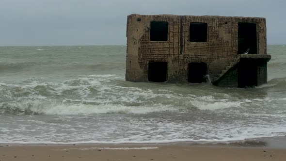 Big stormy waves breaking against abandoned seaside fortification building ruins at Karosta Northern alt