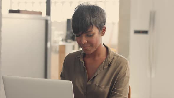 Mixed Race Black Adult Woman with Short Hairstyle Working at Home
