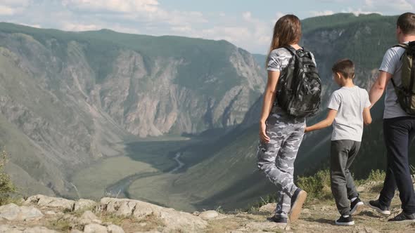 Happy Family Come To the Peak of the Mountain and Look Forward. Successful Family alt
