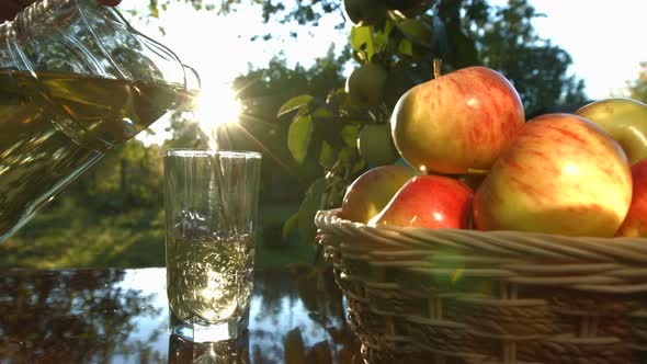 Apple juice and basket with apples.