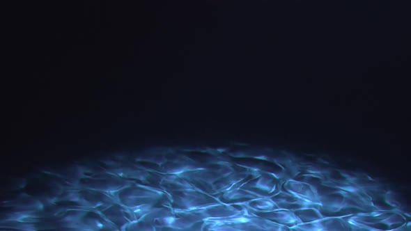 Underwater blue and dark sea floor with caustics at bottom of ocean alt