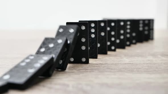 Domino Effect in Slow Motion  Falling Black Tiles with White Dots alt