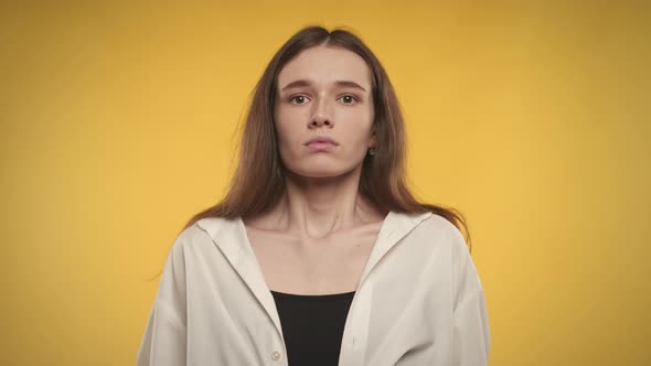 Woman Taking a Deep Breath and Exhale on a Bright Yellow Background alt