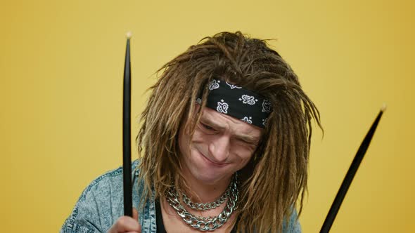 Emotional Musician Playing Drums in Studio. Man Holding Drum Sticks Indoors alt