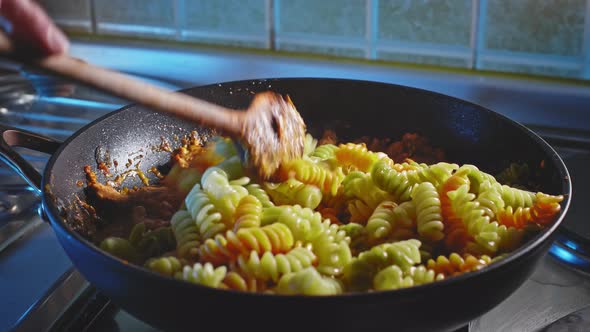 Mixing Cooked Rotini Pasta Into Cheese And Mayonnaise Sauce With Chicken Breast In Pan. close up alt