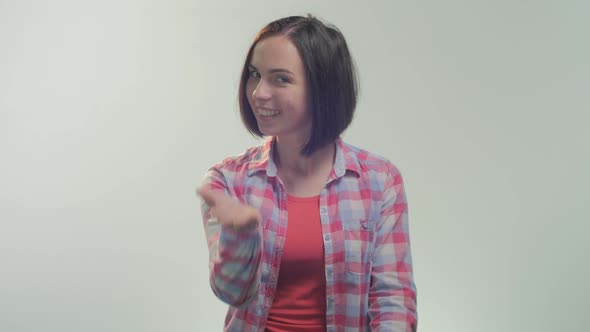 Woman gesturing and beckoning  alt