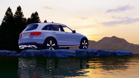 White Luxury Off-Road Vehicle Standing on Rocks with Sunset View