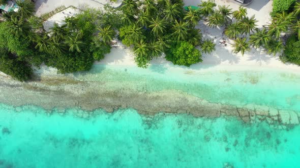 Wide angle aerial island view of a summer white paradise sand beach and turquoise sea background in  alt