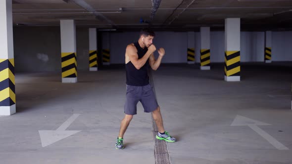Boxer Does Training Punches in Underground Parking alt