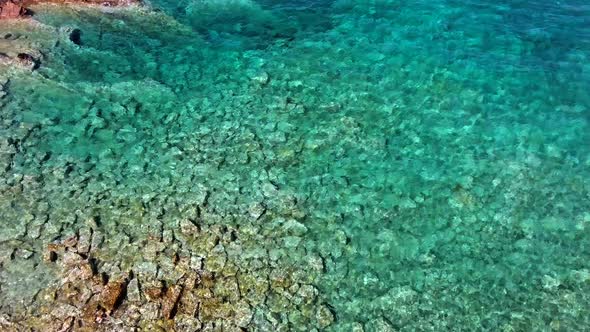 Clear and Shallow Sea Water of the Cove Surrounded by Stone and Rocky Coastline