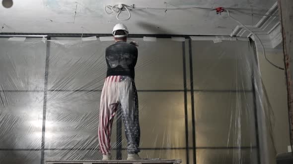 Portrait of Happy American Construction Worker in Uniform Dancing and Smiling Doing House Renovation alt