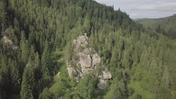 Stone rocks Ternoshorska Lada amidst beautiful scenic Carpathian forests, Ukraine alt