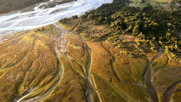 Tilt down aerial view of Rio Blanco, Hornopiren, Hualaihue, Chile. In the sunset light alt