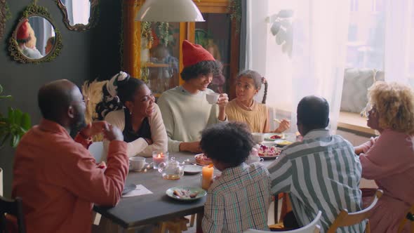 Large Family Having Holiday Dinner and Speaking alt