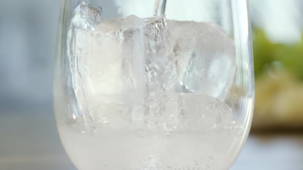 Pouring Mineral Water Over Ice Cubes