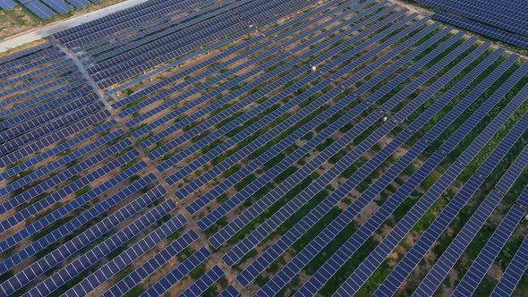 Aerial Shot of a Huge Solar Power Plant in a Big Field. Electricity Generation From Solar Energy alt