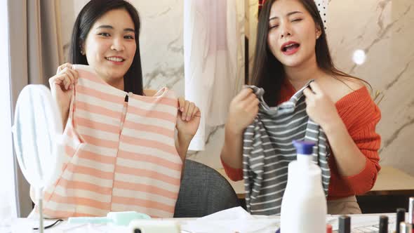 Portrait of young asian Fashion blogger woman review product, alt