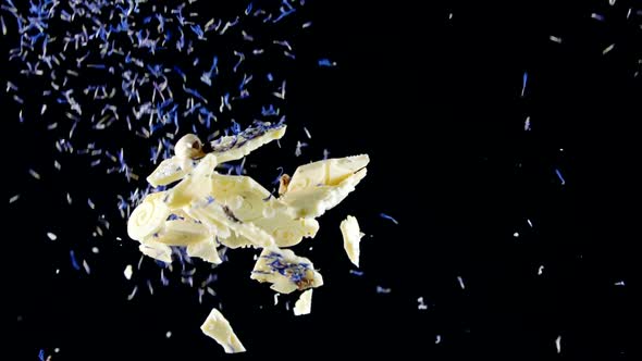 Delicious Truffles in Coconut Flakes Flying in Slow Mo Isolated Black Background