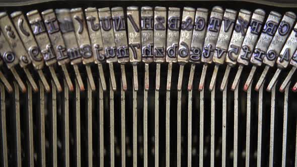 Mechanism of a retro typewriter. Old typewriter hammers. Close up. alt