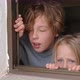 Sister and Brother Looking Outside Through the Open House Window - VideoHive Item for Sale