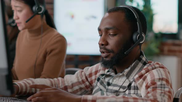 Young Man Answering Telework Call at Customer Service Job alt