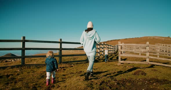 Carefree Family on Spring Time Road Trip Adventure Walk on Meadow at Countryside alt