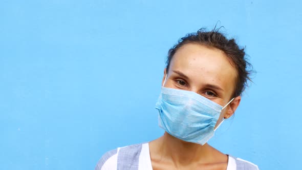 The Young Woman Recovered From the Flu and Takes Off the Mask with a Smile on Her Face alt