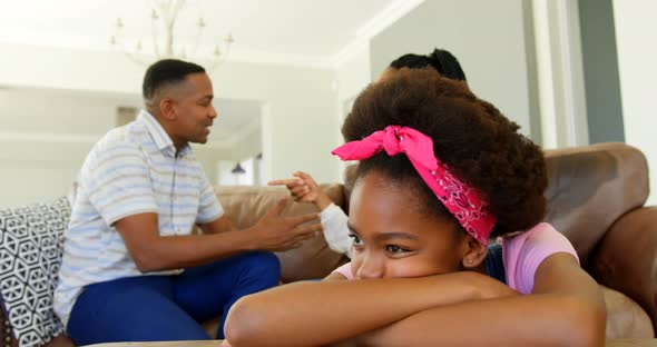 Side view of young black parents sitting on the couch and arguing in a comfortable home 4k alt