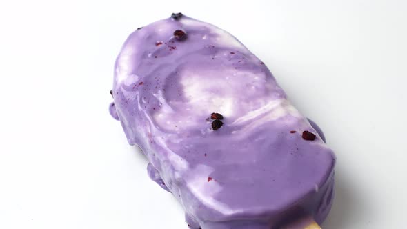 Lavender purple cold ice cream melt on white background. 4K video of ice cream. alt