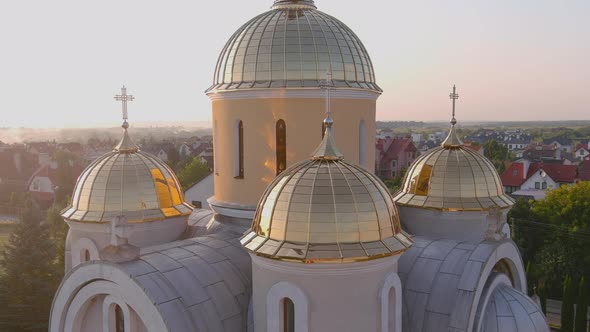 Bright Ukrainian Church in the Country with Golden Domes and Bell Tower alt