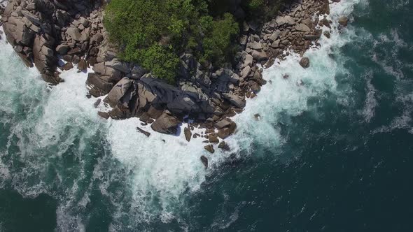 View From a Drone Vertically Down on a Stone Cape Washed By Strong Waves alt