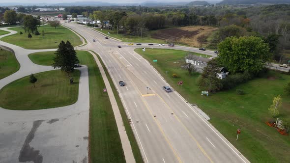 Rural highway in western Wisconsin. Large rest area present along with forest and mountains.